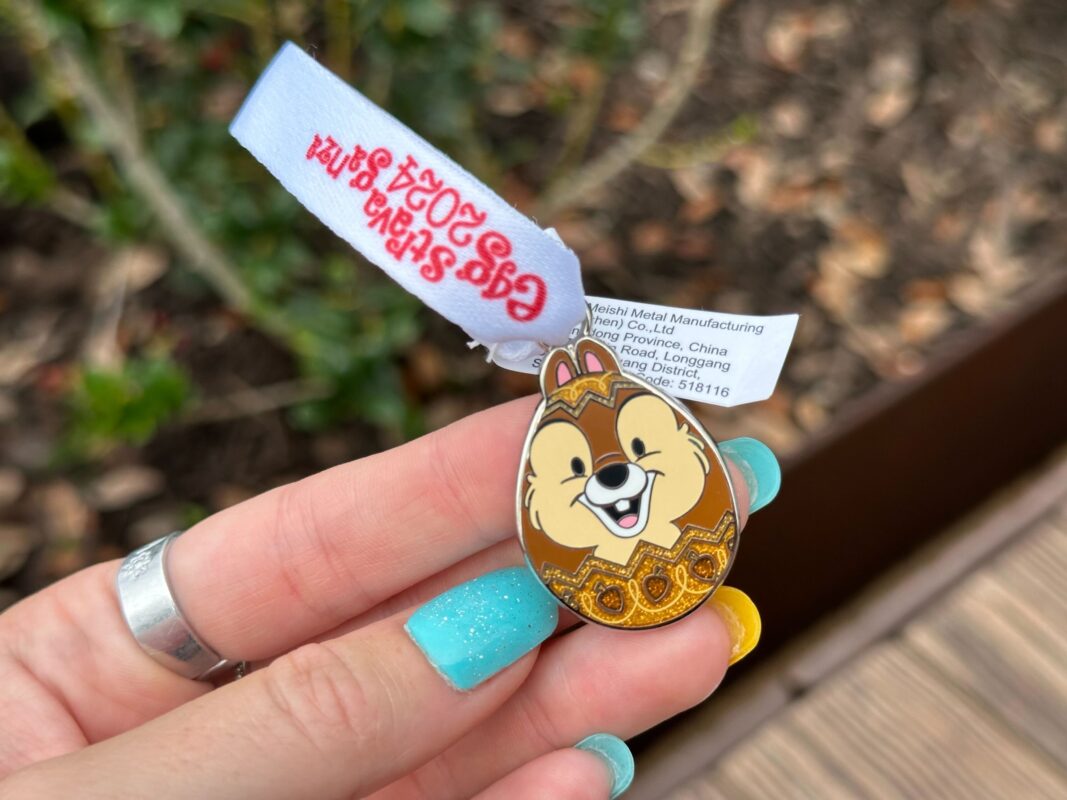 A reporter's hand holds the Chip prize charm for Eggstravaganza 2024.
