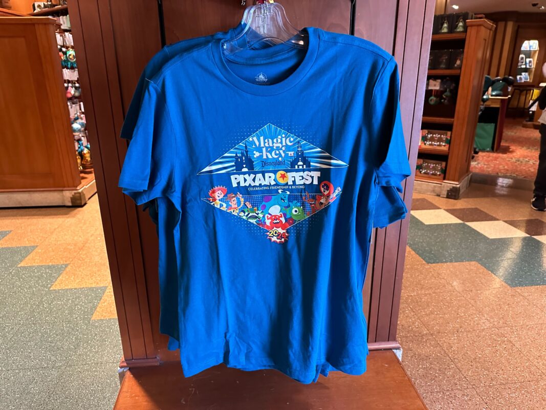 Magic Key Pixar Fest T-shirt hanging on a clothing rack.