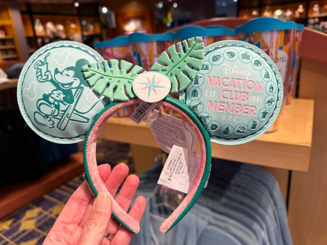 A reporter holding the DVC tropical Loungefly ear headband