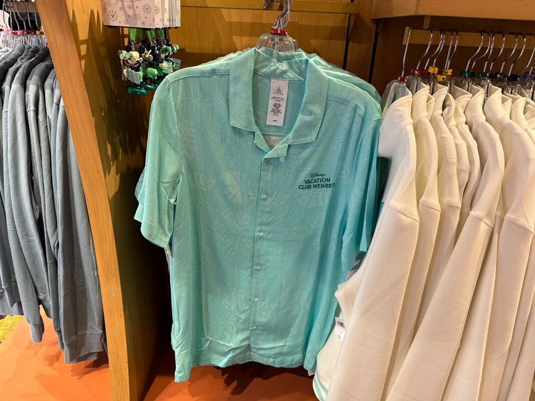 DVC short-sleeved button-up hanging on a merchandise display.