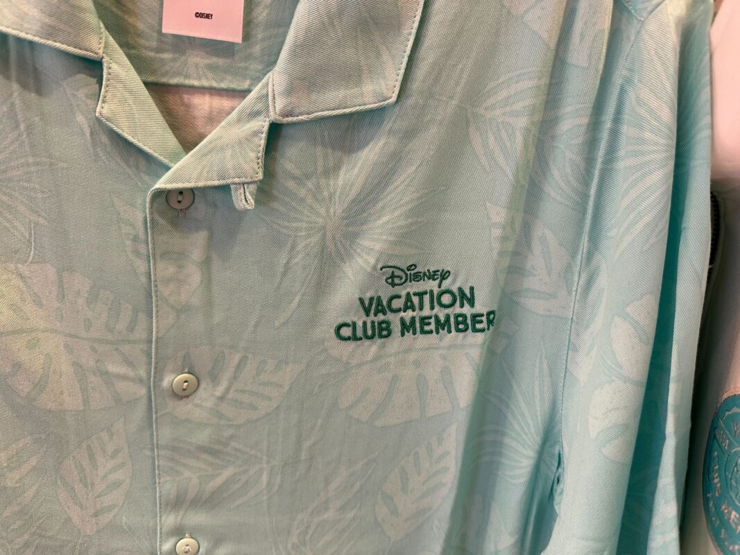 A close-up of "Disney Vacation Club Member" embroidered on the button-up shirt.