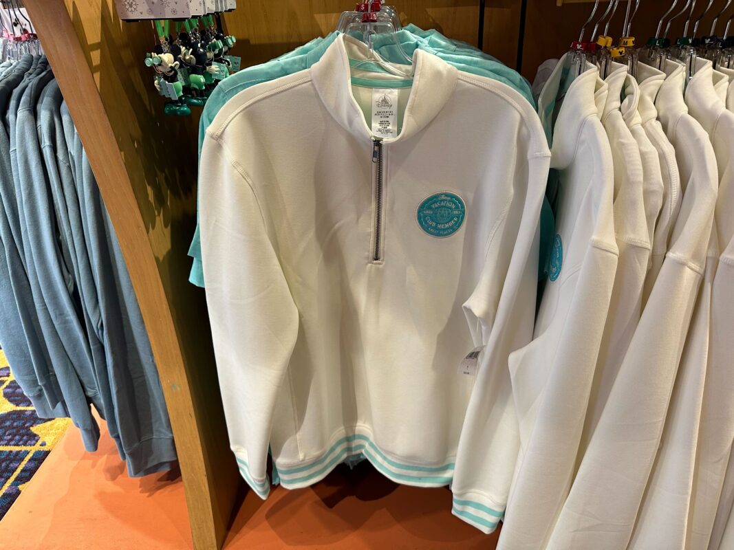 DVC half-zip jacket hanging on a clothing rack.