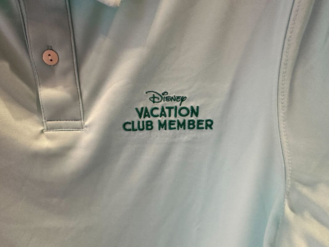 A close-up of the embroidered Disney Vacation Club wordmark on the polo.