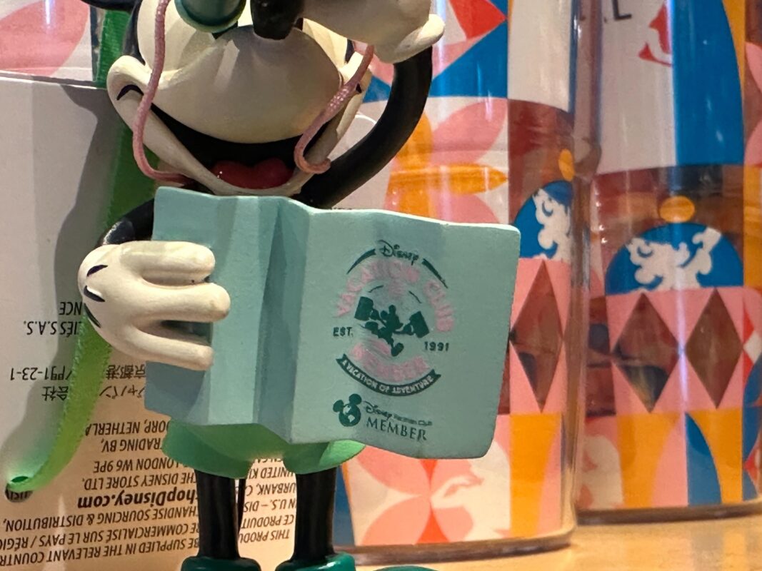 A close-up of the teal map that Mickey is holding in the ornament.
