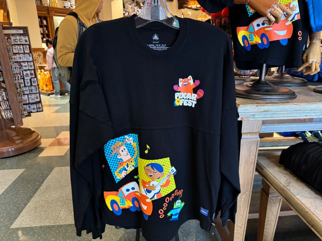 A photo of the front of the Pixar Fest Spirit Jersey hanging on a rack.