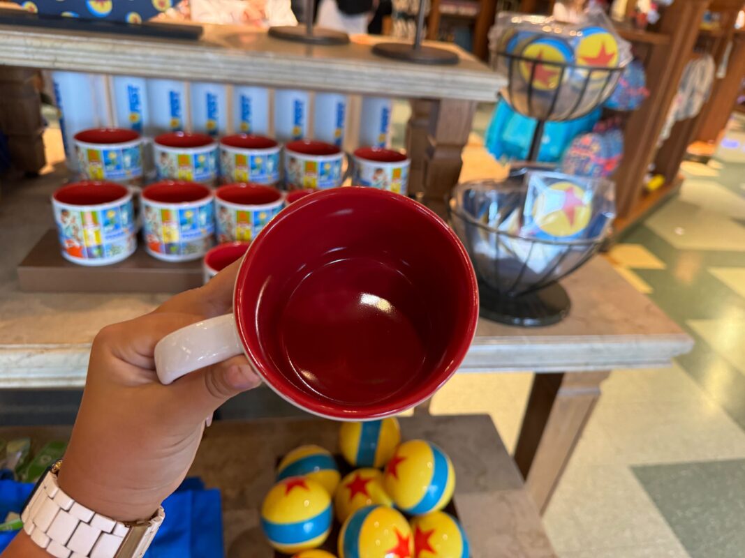 A reporter's hand showing the inside of the ceramic mug.
