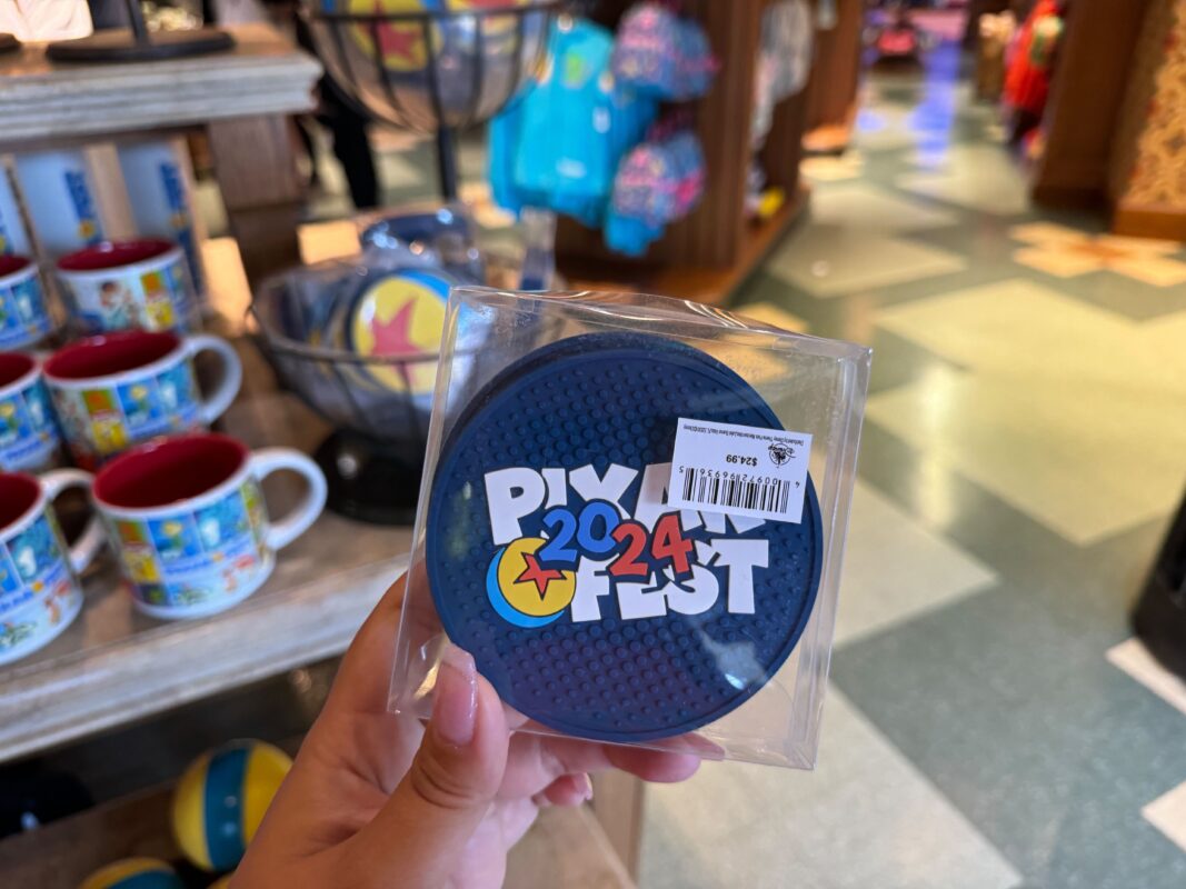 A reporter's hand holding a Pixar silicone coaster set.