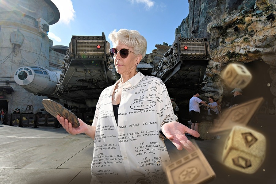 A person with short white hair and sunglasses stands in front of a spacecraft, holding a tablet with one hand and open palm with the other. Floating dice are seen in the foreground, creating perfect new PhotoPass opportunities reminiscent of magical moments at Walt Disney World.