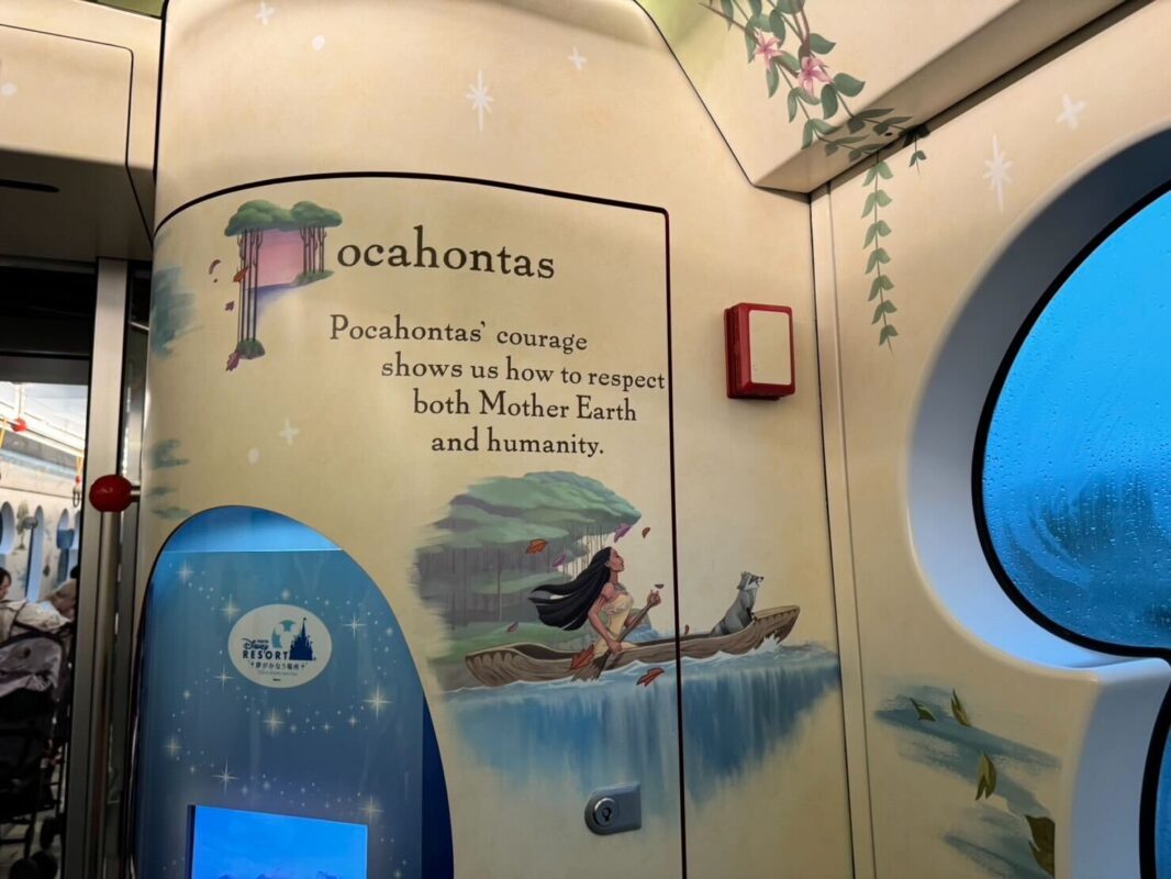 Interior of a themed train car decorated with an illustration of pocahontas rowing a canoe and text celebrating her courage and respect for earth and humanity.