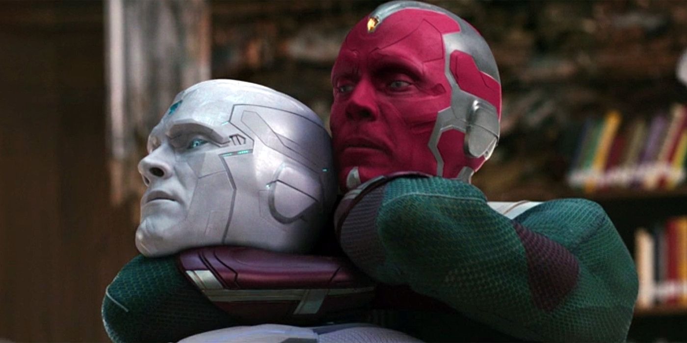 Vision, a character with red skin holds White Vision in a headlock, both wearing similar armor.