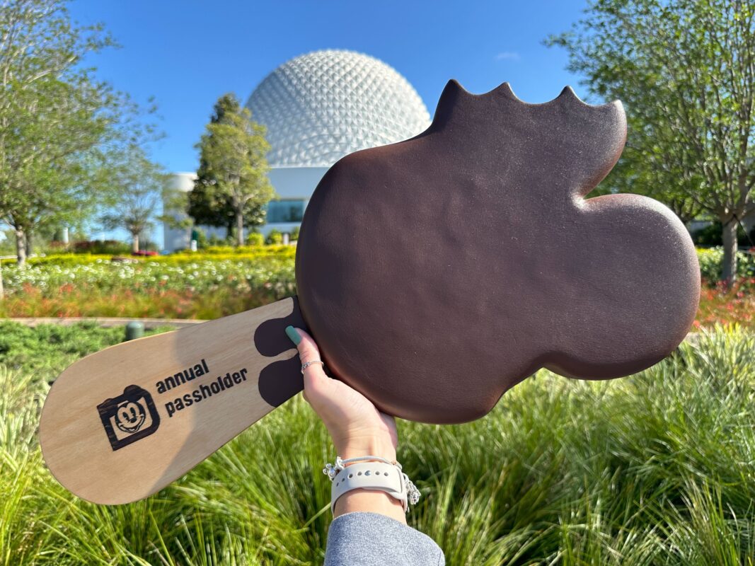 Giant Mickey-shaped ice cream bar prop held in front of Spaceship Earth