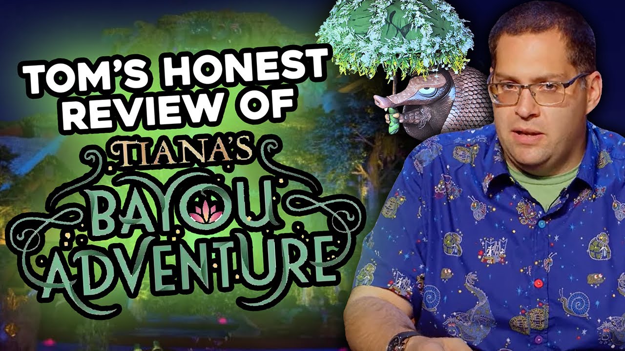 A man in a print shirt stands next to the text "Tom's Honest Review of Tiana's Bayou Adventure" with a themed park background, featuring a decorative bayou-themed animal.