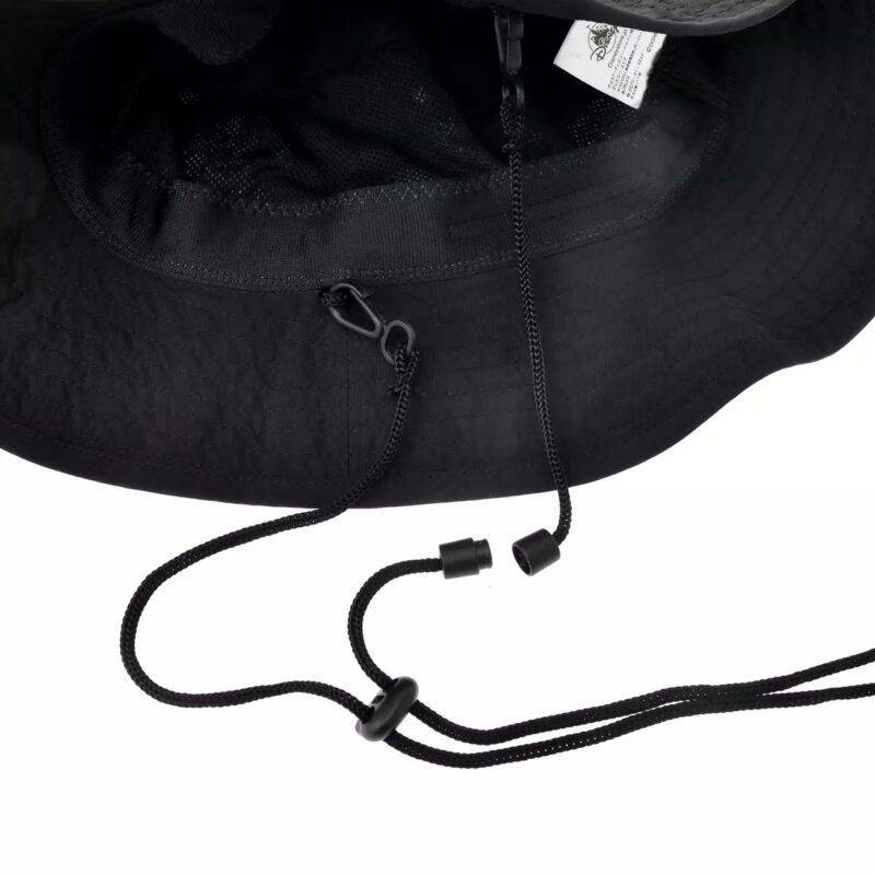 Black wide-brimmed hat with adjustable chin strap and toggles, featuring a mesh interior and a small tag with text information.