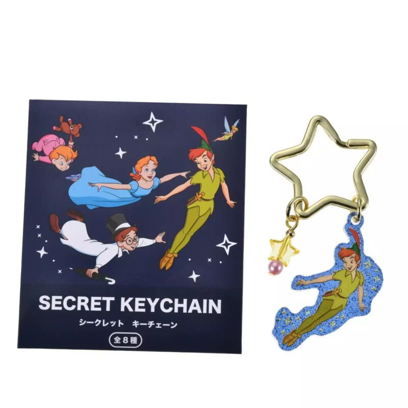 A "Secret Keychain" set featuring a star-shaped keyring with a Peter Pan charm and a box illustration of Peter Pan, Wendy, John, and Michael flying. Includes text in English and Japanese.