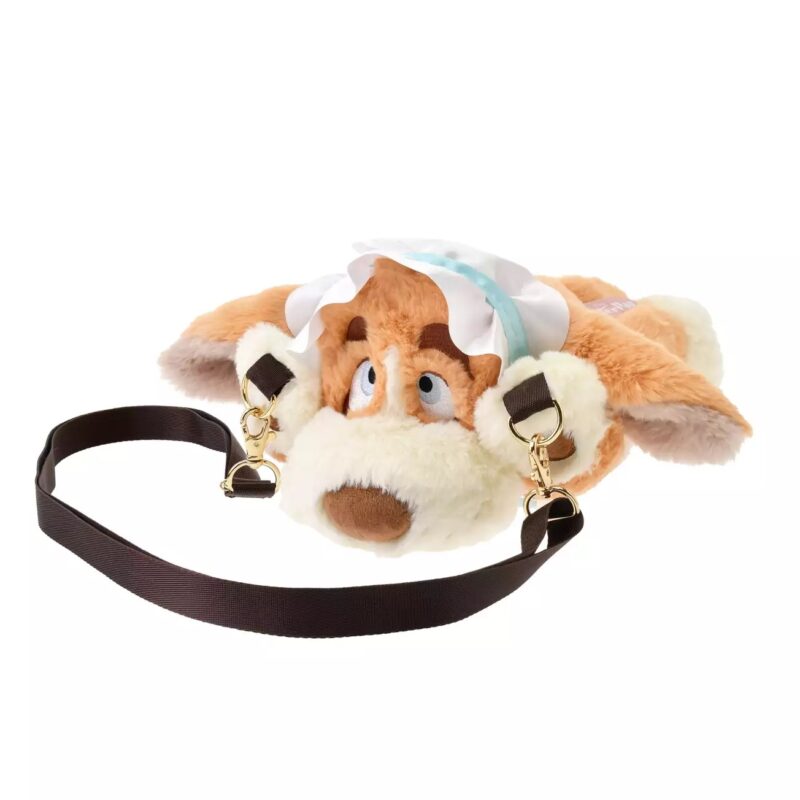 A plush bag shaped like a dog's face, wearing a bonnet, with a detachable black strap attached to both sides.