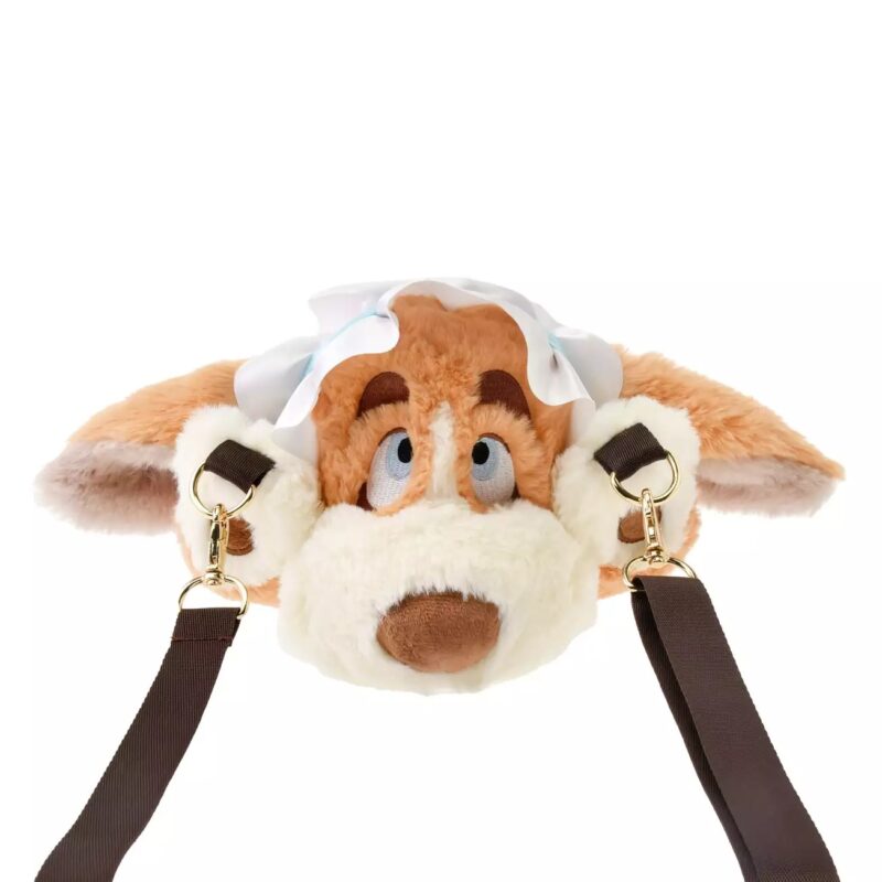 Plush animal head-shaped bag with large ears and a white cap, featuring brown and beige fur, blue eyes, and brown straps attached to its sides.