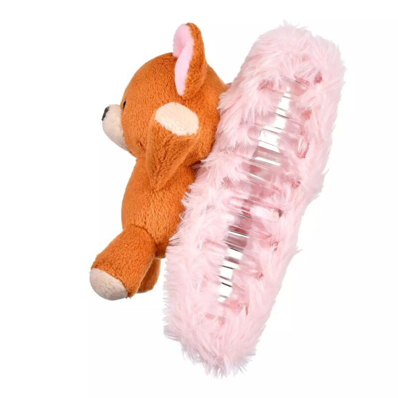 A brown stuffed bear attached to a large pink fluffy hair clip with metallic teeth.