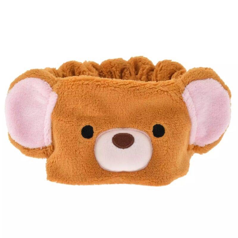 A brown fabric headband with bear ears and an embroidered bear face, featuring round black eyes, a pink nose area, and large pink inner ears.