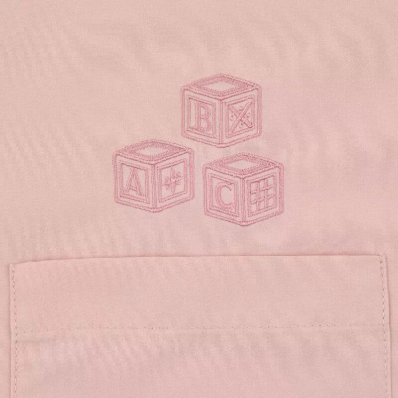 Three embroidered alphabet blocks (A, B, C) are depicted on a pink fabric background above a pocket.