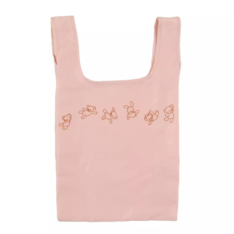 A pink reusable tote bag decorated with a line of cartoon illustrations depicting bears in various playful poses.