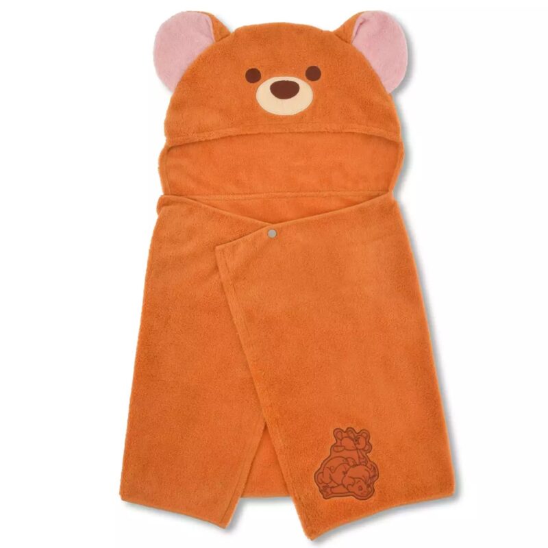 A brown hooded towel designed to look like a bear, featuring bear ears, eyes, and nose on the hood. The towel has an embroidered bear and cub at the bottom corner.