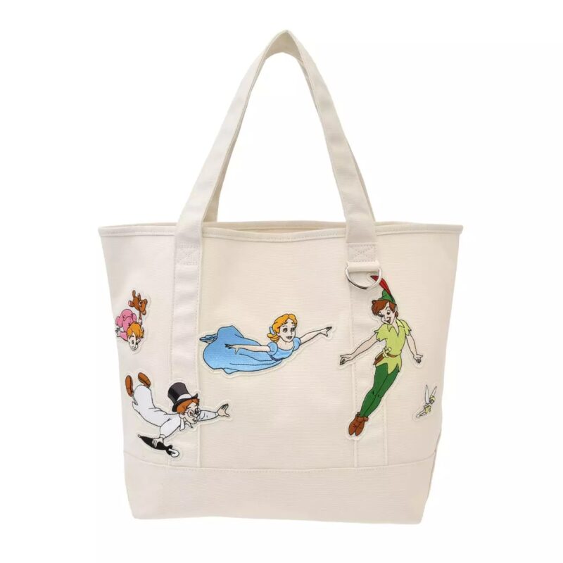 A white tote bag featuring embroidered characters from Peter Pan, including Peter Pan, Wendy, John, and Michael flying, plus Tinker Bell on the front.