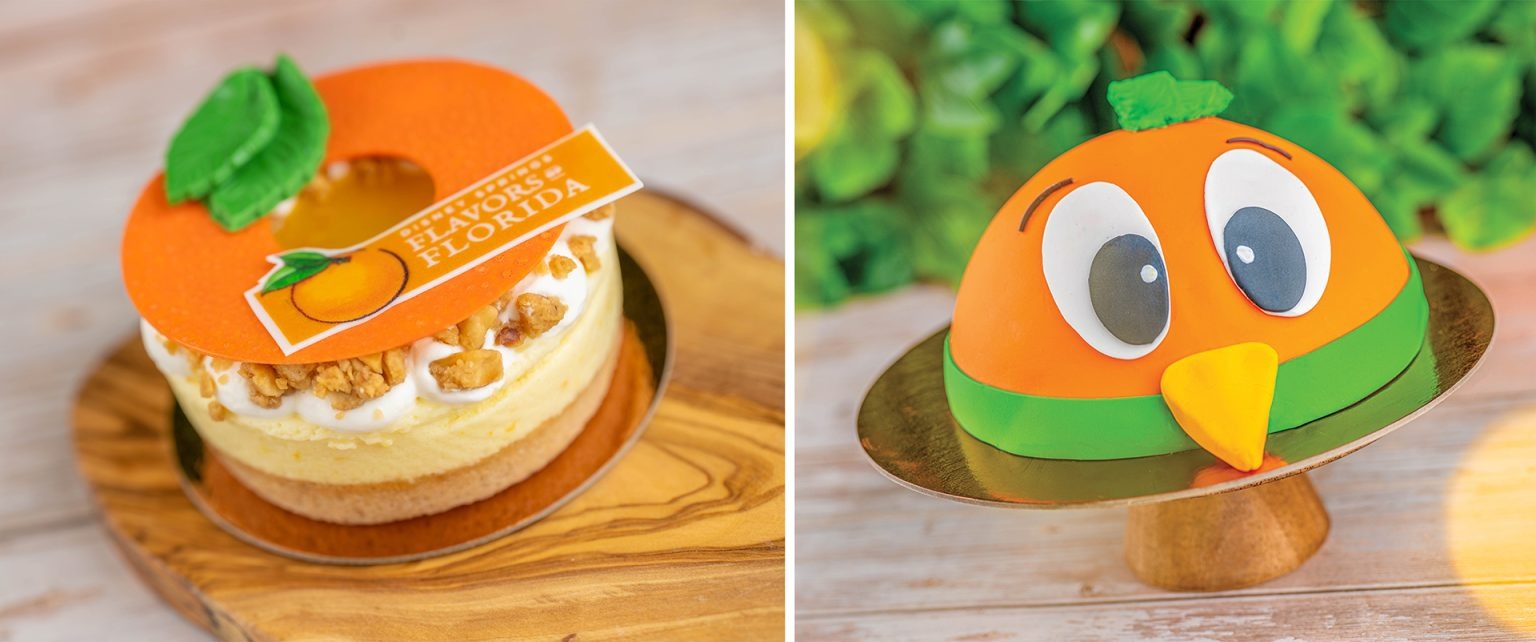 Two cakes shaped like oranges. The left cake resembles an orange slice with text "Florida," and the right one is decorated with a cartoonish orange face and green leaves. Both are displayed on wooden boards.