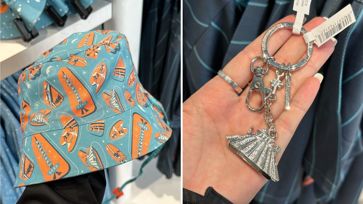 A close-up of a blue Tomorrowland bucket hat featuring an orange and white swan pattern is on the left. On the right, a person's hand holds a silver keychain with various symbols, including a fan and a flower.