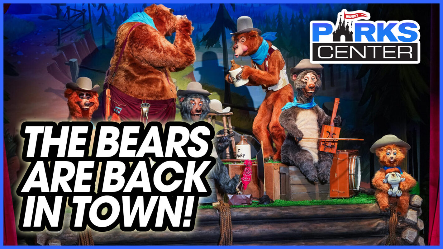 A group of animatronic bears dressed in cowboy attire perform onstage. A sign reads "The Bears Are Back in Town!" with the ParksCenter logo proudly displayed above.