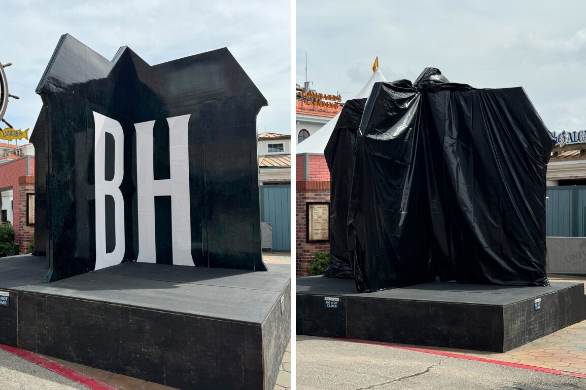 A split image shows a "BH" sculpture, hinting at Blumhouse, in the left panel and the same sculpture covered in black plastic in the right panel, both placed on the same outdoor platform.