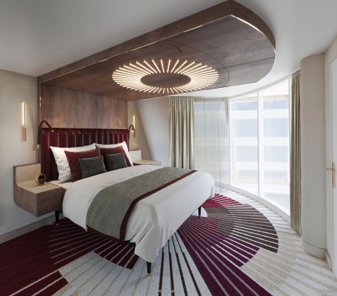 A modern hotel room with a large bed, circular light fixture above, and large curved windows with closed curtains. The carpet features a geometric pattern in burgundy, white, and tan, evoking a sense of Disney-inspired magic in its design.