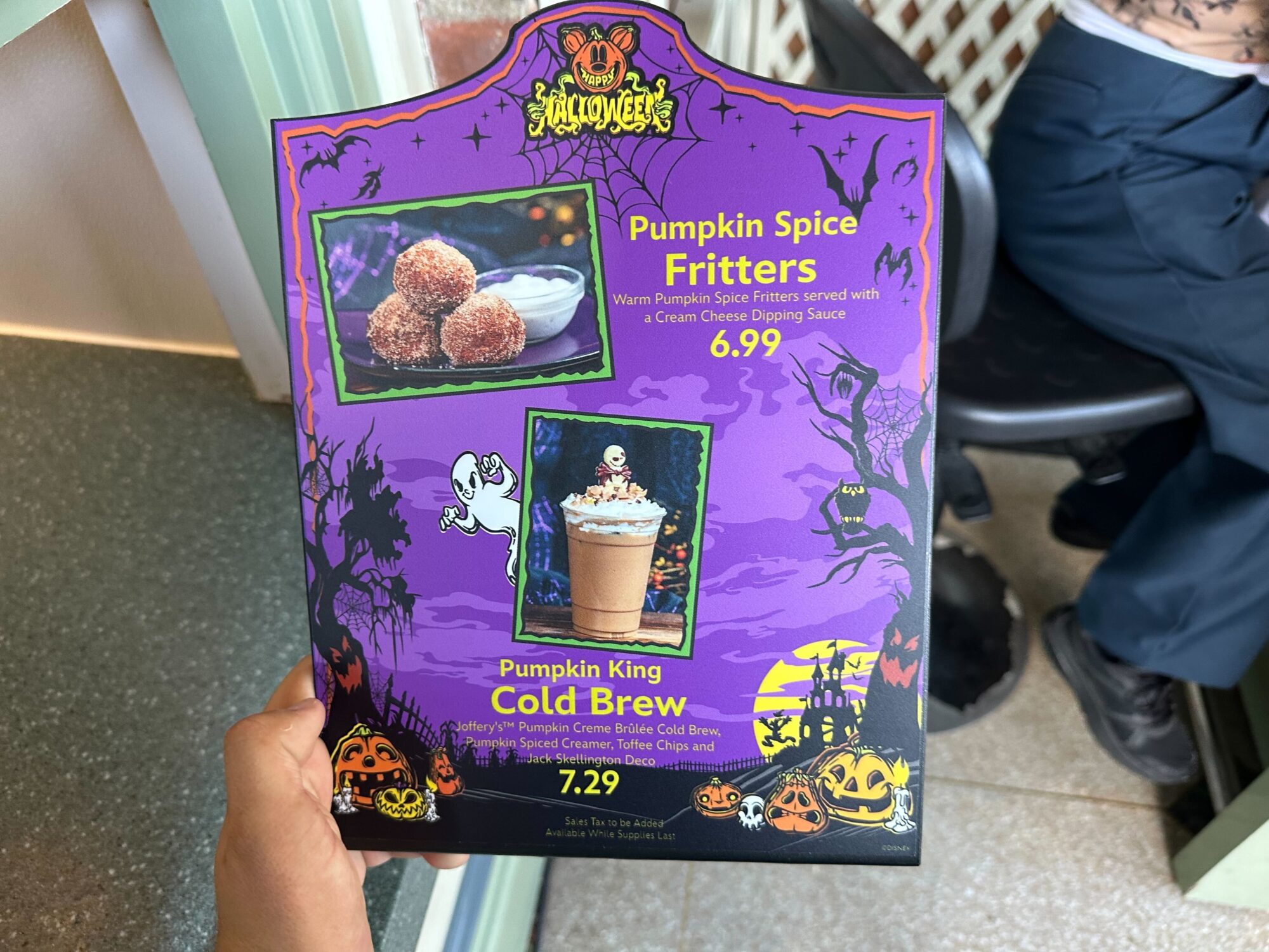 A menu features Halloween-themed items: Pumpkin Spiced Fritters for $6.99 and Pumpkin King Cold Brew for $7.29. The design includes pumpkins, ghosts, and a spooky Halloween background.