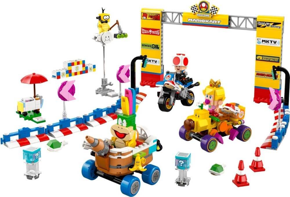 A Lego Mario Kart set featuring various Super Mario characters, karts, and track elements, including a start/finish line, colorful blocks, traffic cones, and a playful racing environment.