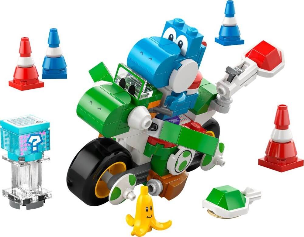 A LEGO set featuring a blue Super Mario character riding a green and white vehicle, surrounded by orange and blue traffic cones, a blue box with a question mark, a banana peel, and a green turtle shell.