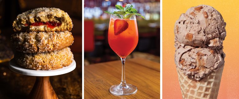 A trio of treats: A stack of sugar-coated cookies filled with red jam, a glass of red cocktail garnished with a strawberry, and a double scoop of nutty ice cream in a waffle cone—perfect for celebrating Hispanic and Latin American Heritage Month at Disneyland.