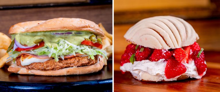 Two sandwiches: one with fried chicken, lettuce, tomato, and avocado; the other with strawberries and cream inside a sweet bun—perfect for celebrating Hispanic and Latin American Heritage Month at Disneyland.