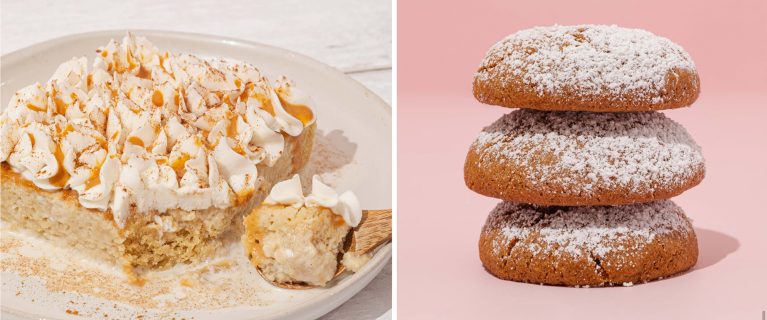 A slice of cake with whipped topping and nuts on a plate next to a spoon. Beside it, three stacked cookies dusted with powdered sugar against a pink background, reminiscent of the festive treats enjoyed during Hispanic and Latin American Heritage Month at Disneyland.