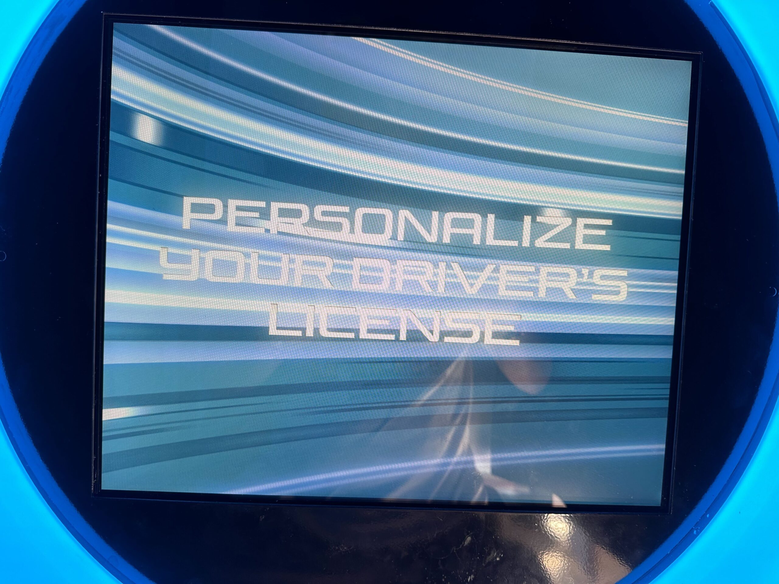 A screen displays the text "Personalize Your Driver's License" with a blue, striped background.