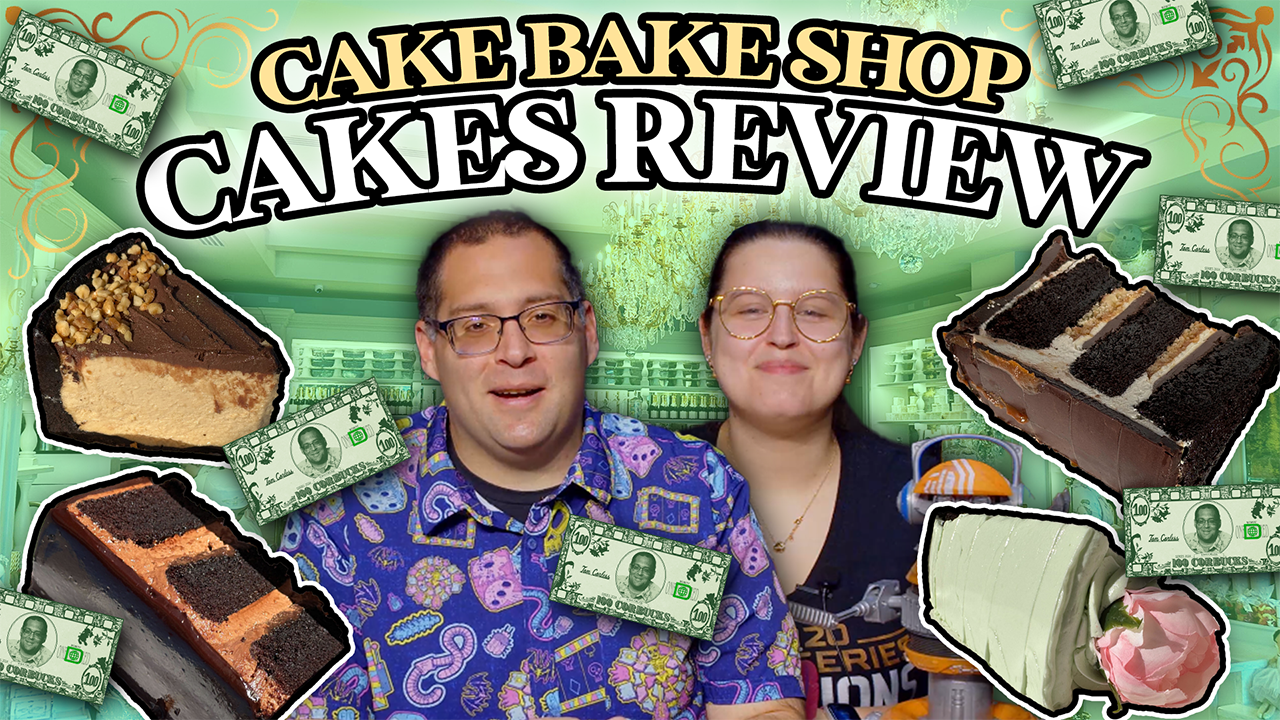 Two people stand before a backdrop adorned with cake slices and dollar bills. The text reads "Cake Bake Shop Cakes Review," celebrating the bakery's delicious offerings.
