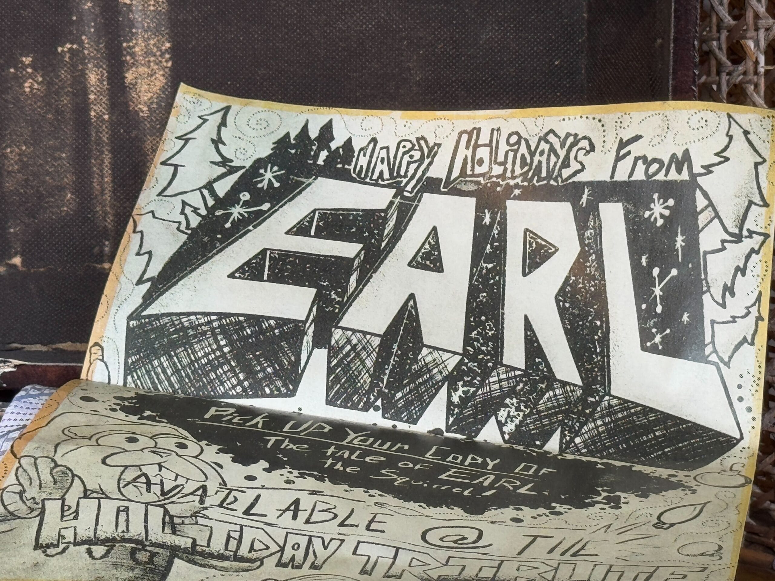 A vintage holiday-themed comic with bold text, "Happy Holidays from EARL." The artwork features a wintery design and a cartoon character promoting "The Tale of Earl.