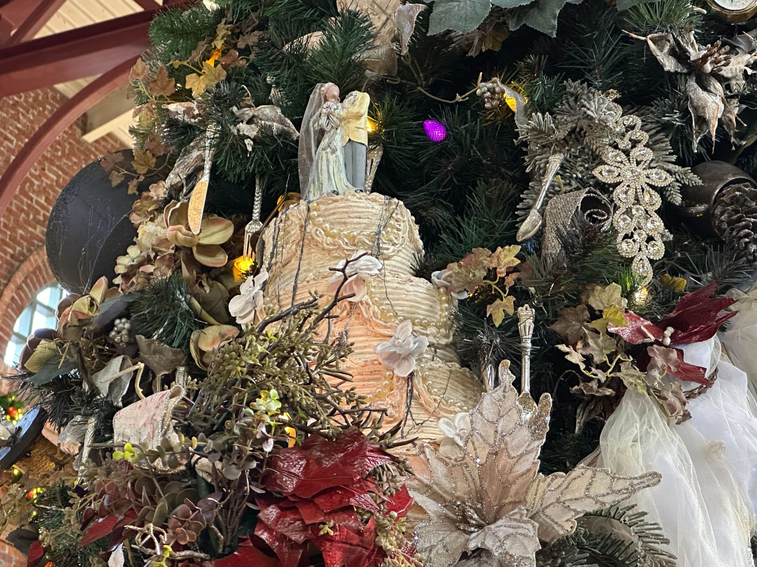 Ornately decorated Christmas tree with a variety of ornaments, including angels, flowers, and lights.
