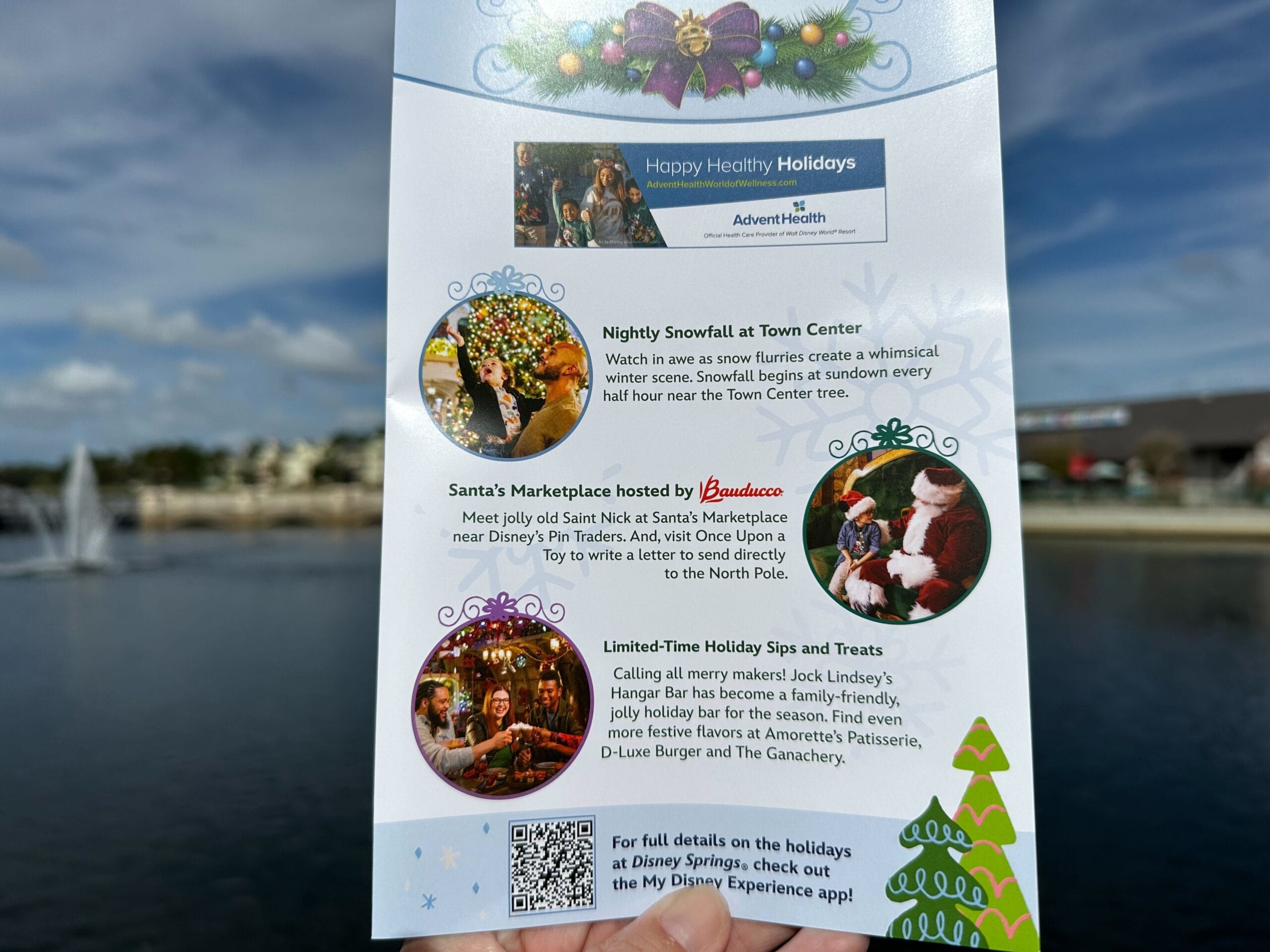 Close-up of a holiday event flyer featuring activities such as nightly snowfall, Santa's Marketplace, and holiday treats, with an AdventHealth logo at the top. Enjoy festive cheer and embark on the Disney Springs Christmas Tree Stroll for a magical experience.