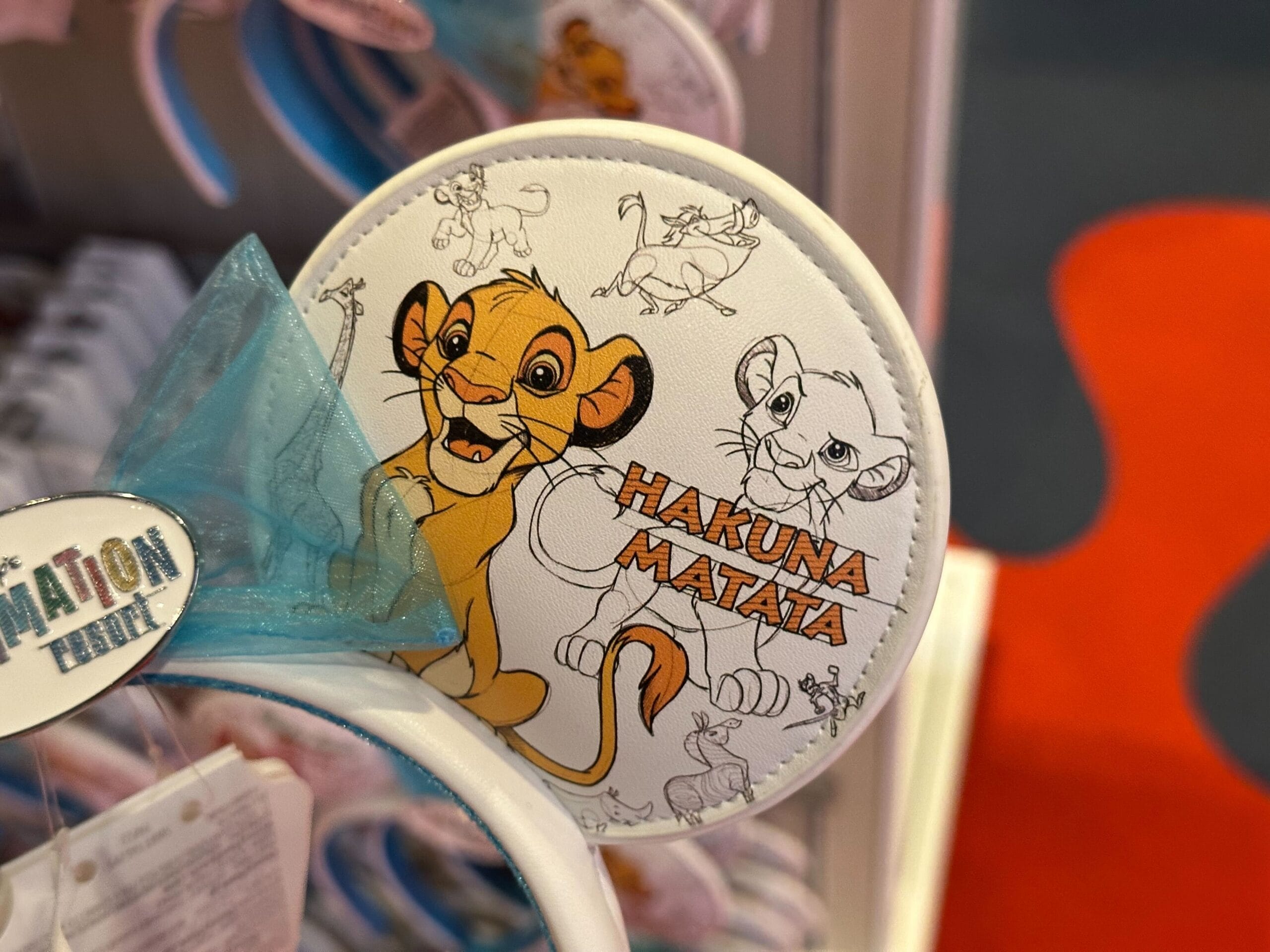 Headband with "Hakuna Matata" design featuring illustrated characters from a popular animated movie.