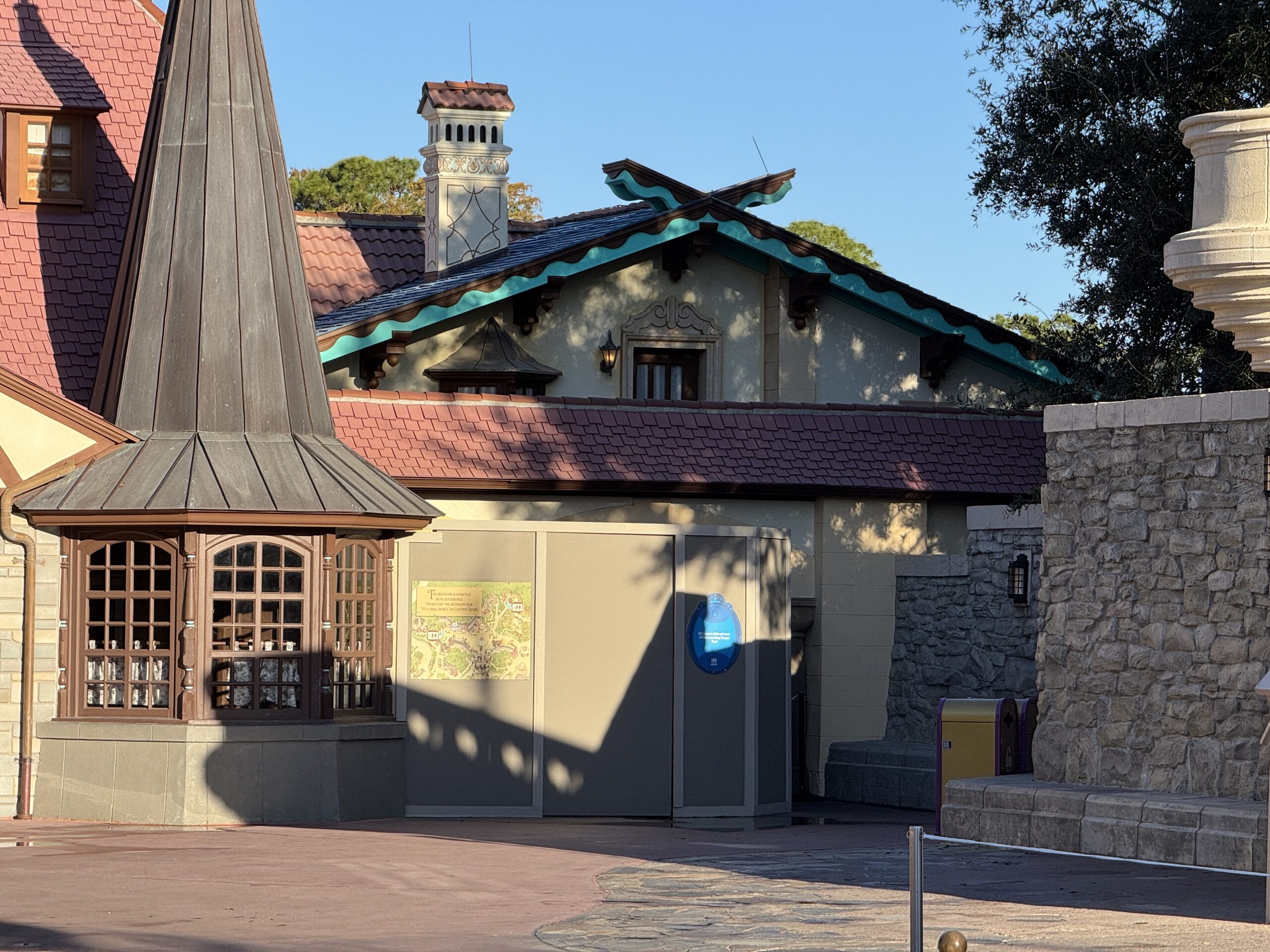 Construction barriers and closed gates stand before a building with a turret and stone walls, resembling an entry to the Magic Kingdom. PHOTO REPORT: 12/7/2024.