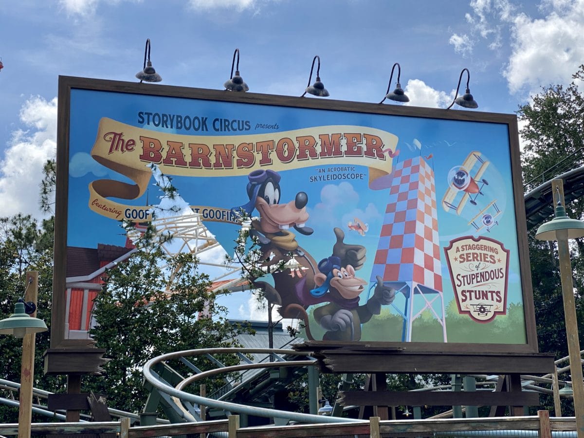 A colorful Barnstormer billboard features Goofy as a stunt pilot at Storybook Circus.