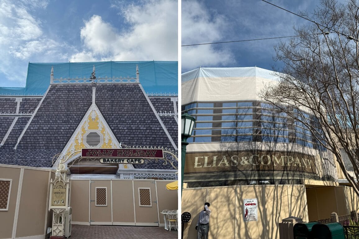 Two buildings under construction at Disneyland Resort are covered in themed scrims. The left reads "Jolly Holiday Bakery Café," and the right says "Elias & Company." A sign indicates the café is open.
