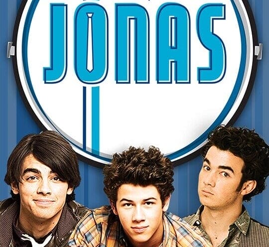 Three young men stand in front of a "JONAS" sign against a blue backdrop, reminiscent of the Jonas Brothers' charm.