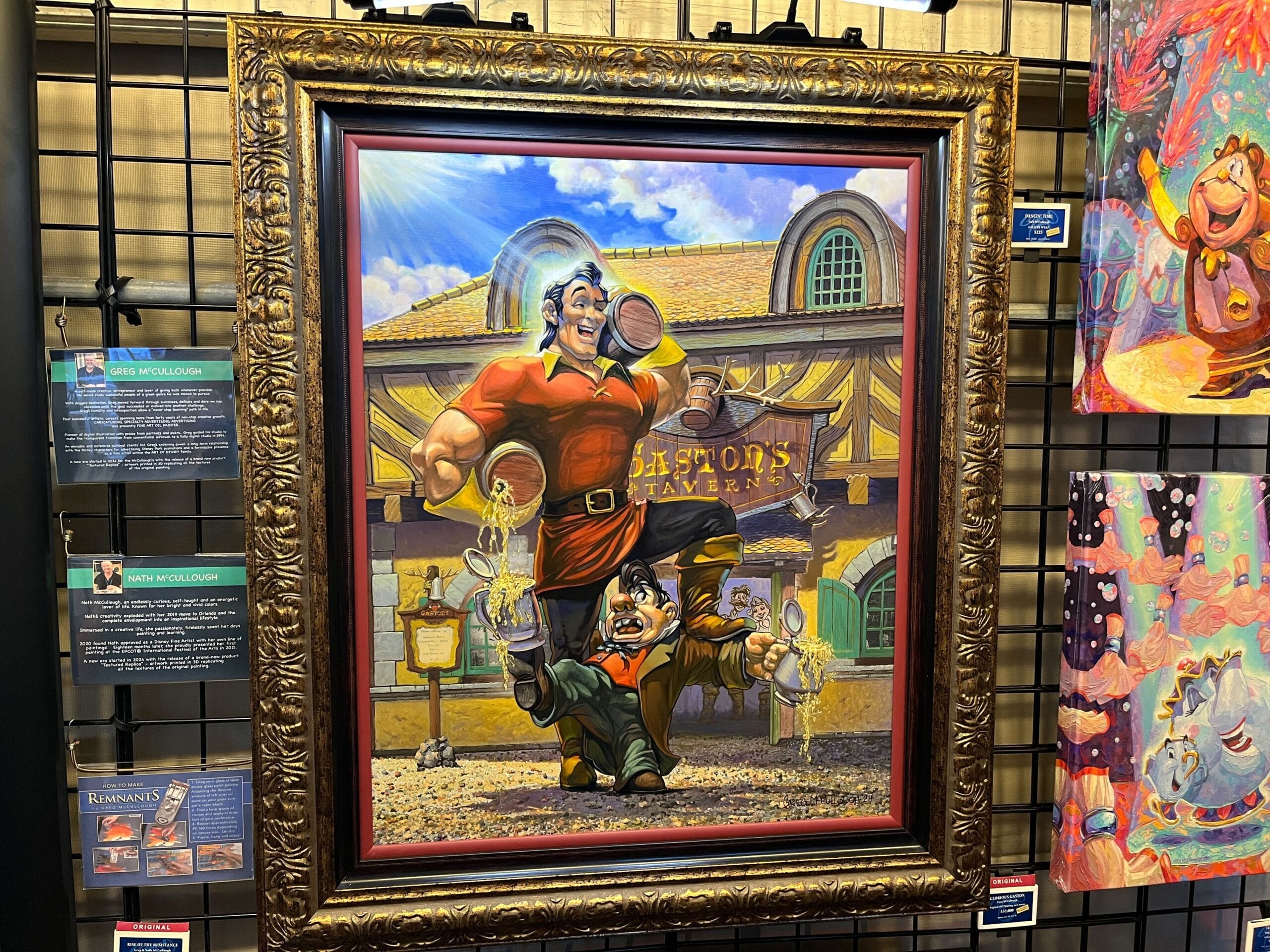 A framed painting of Gaston, proudly clutching beer mugs with LeFou outside Gaston's tavern, is a standout. Nearby, colorful artworks add vibrancy that echoes the spirit of the EPCOT International Festival of the Arts.