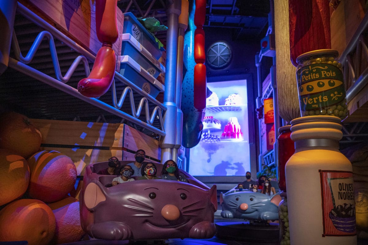 Guests ride in mouse-shaped cars through a giant pantry on Remy's Ratatouille Adventure at WDW.