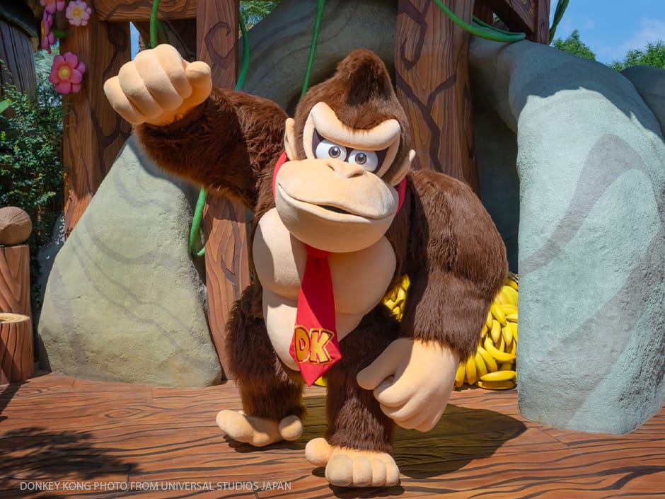Costumed Donkey Kong character posing with a fist raised in a themed area at Universal Studios Japan.